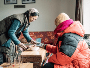 A Ladakhi host serving traditional butter tea